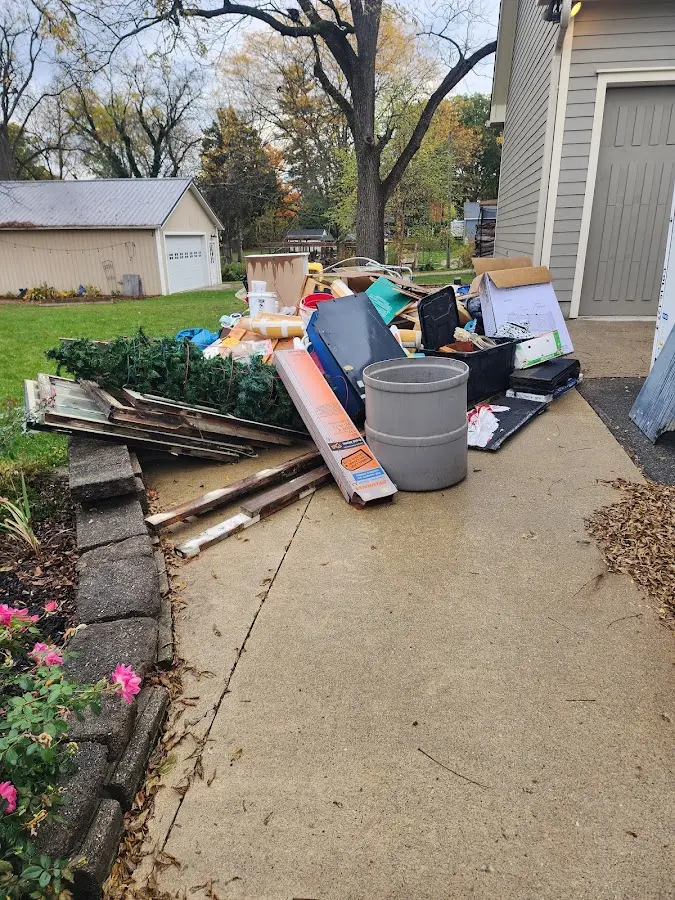 Dumpster being loaded with debris for Estate Cleanout Dumpster Rental in Yulee